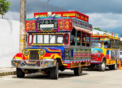 Traditional Chiva buses parked on a street in Colombia