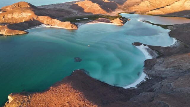 Spectacular drone view of Balandra turquoise beach, sandbars and arid hills in Mexico at sunset