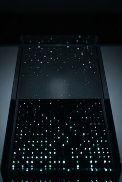 Rain of 3D lights scattered across dark glass