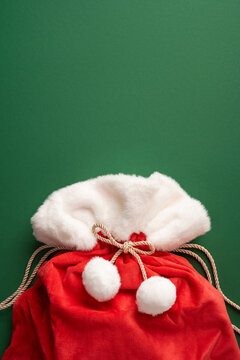 Santa bag with present on vertical green background for Christmas and New Year holiday