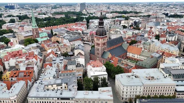 Riga Cathedral dominates the compact Old Town as the camera flies high above a dense mix of historic rooftops and streets.