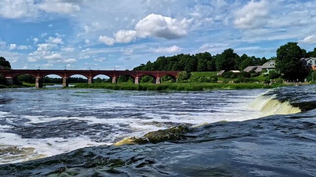 Venta Rapid waterfall flowing over the Venta River in Kuldiga, Latvia, on a sunny summer day