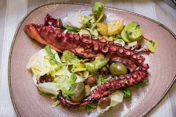 Grilled Mediterranean octopus tentacle salad with asparagus in Sanremo, Italy © SvetlanaSF