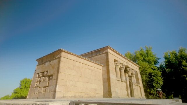 A wide angle shot of the historic Temple of Debod, an ancient Egyptian temple relocated to Madrid, Spain. Suitable for travel documentaries and historical tourism content.