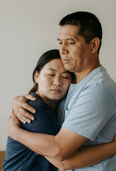 Fototapeta premium Emotional support and empathy, man comforting a sad woman with a gentle hug, relationship and mental health