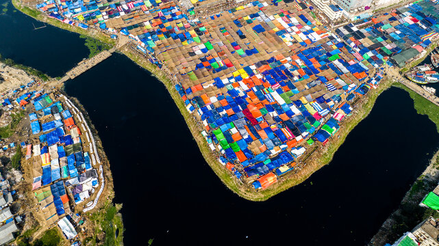 Aerial view of the massive Bishwa Ijtema gathering with thousands of colorful tents and shelters along the riverbank in Tongi, Dhaka Division, Bangladesh.