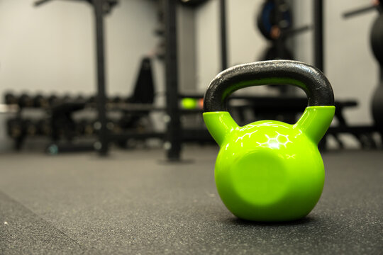 a kettlebell lies on the floor in the gym