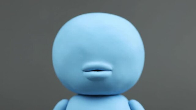 Close up of a blue clay character with a beak and lips.