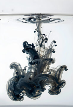 Black ink dissolving in clear water fluid motion and chemical reaction science and art concept isolated on white backgrounds