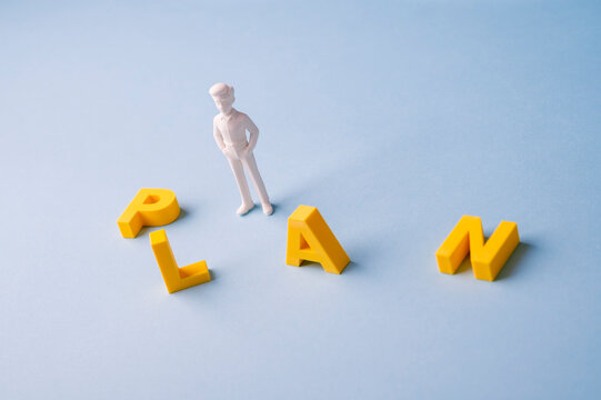 Business planning and strategy concept with businessman among PLAN letters