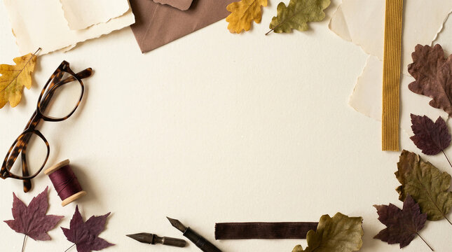 Autumn poetcore stationery flat lay with blank paper, fountain pen, glasses, thread, torn pages, velvet ribbon and dried leaves, creative writing and publishing concept with copy space