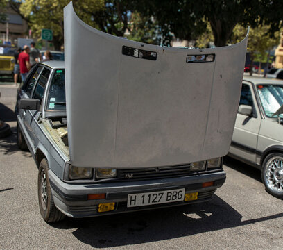 Tavernes Blanques, Spain - June 14, 2026. Silver Renault TXE with open hood on display at car event under bright sunlight