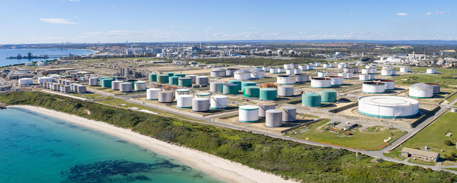 Kwinana Beach, Western Australia, Australia - 15 August 2026: Aerial view of the BP Kwinana Terminal with numerous large cylindrical storage tanks along the coastline.