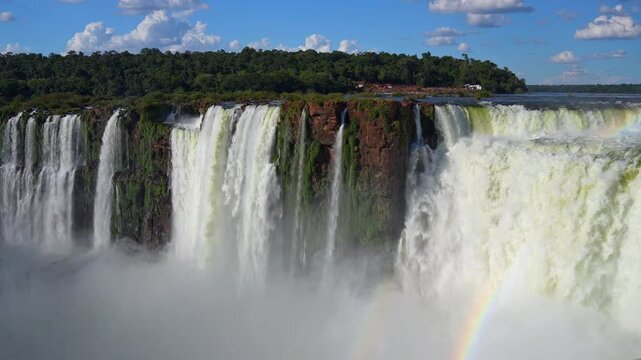 Aerial view of waterfalls with rainbow and lush tropical forest in Argentina and Brazil
