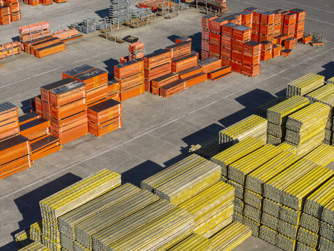 Jaworzno, Poland - 09 August 2026: Aerial view of the PERI Polska Sp. z o.o. facility showing large organized stacks of orange construction formwork