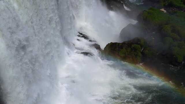 Aerial view of waterfalls with rainbow and lush vegetation