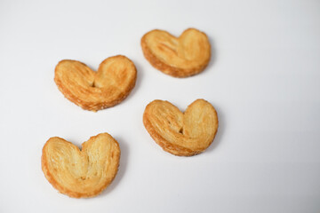 Fototapeta premium Delicious Heart Shaped Palmiers Cookies on White Background.
