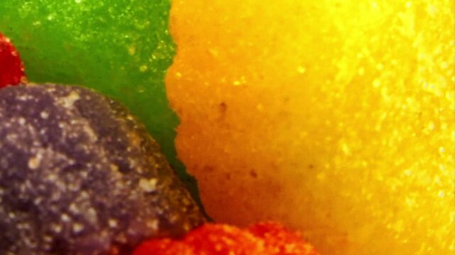 Close up macro shot of colorful jelly candy and gummy sweets with sugar coating