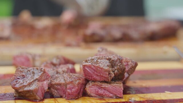 Juicy grilled beef cubes resting on cutting board