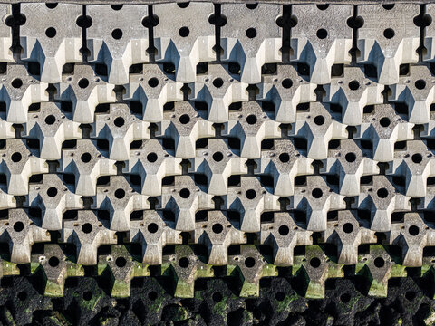 Aerial view of interlocking concrete coastal defense blocks arranged in a repeating pattern along the dike in Breezanddijk, Friesland, Netherlands.
