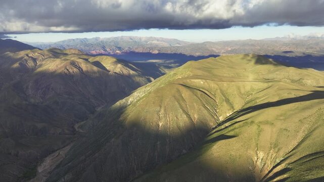 Cinematic golden foothills in Jujuy, Argentina beneath storm clouds