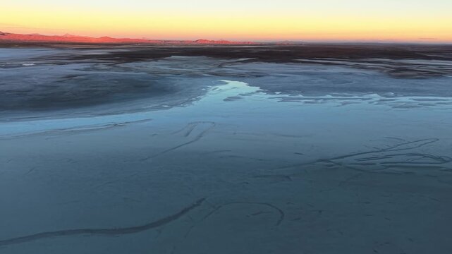 Sunset over Salar de Uyuni salt flat in Bolivia