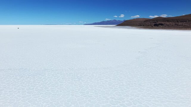 Salar de Uyuni salt flat beneath blue sky in Bolivia