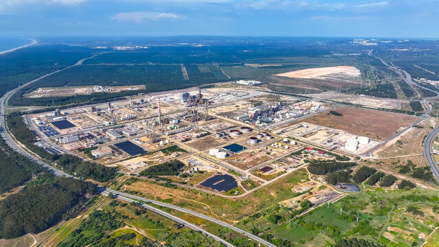 Aerial view of the large oil refinery and industrial manufacturing complex featuring extensive storage tanks, processing units, and surrounding infrastructure in Sines, Setubal, Portugal.