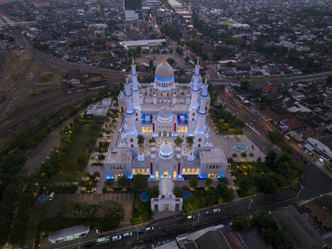 Aerial view of Sheikh Zayed Grand Mosque Surakarta illuminated at night with domes and minarets standing out against the urban landscape in Kecamatan Banjarsari, Jawa Tengah, Indonesia.