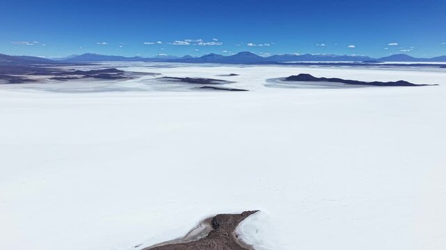 Salar de Uyuni salt flat beneath Bolivia mountain horizon