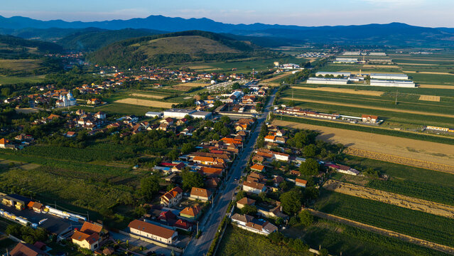 Aerial view of residential houses and agricultural fields in the rural landscape near the town of Deva, Hunedoara, Romania.