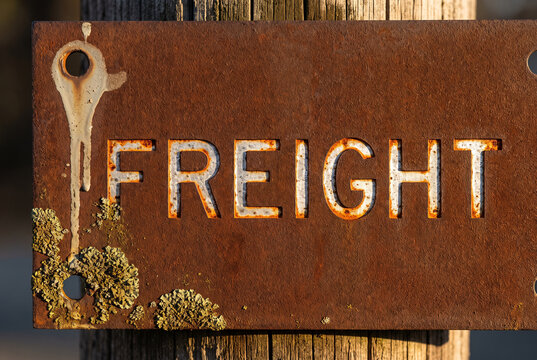 Freight sign on weathered rusted metal with industrial patina