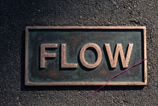 Flow Plaque with Patina Metal Typography on Textured Wall