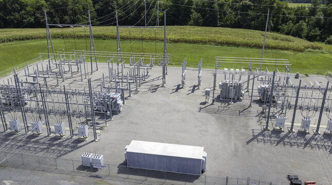 Aerial view of high voltage electrical substation serving a data center with transformers, power lines, and metal structures in a rural setting in Clarksville, Tennessee, United States.