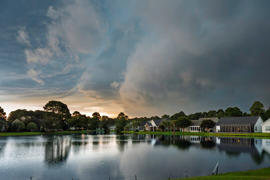 An incoming storm front rolls over a residential lakefront community in the town of Conway, South Carolina near Myrtle Beach in the Southeast region of the US.