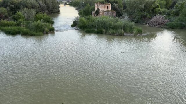 Serene river landscape with ancient building in Cordoba