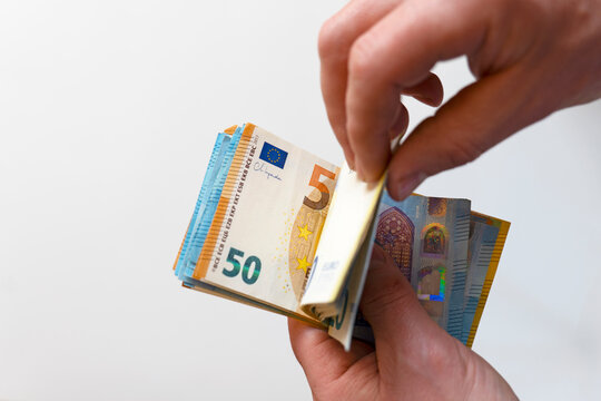 Person Holding Euro Banknotes.Lots of euro banknotes in palms. Money fan in hands