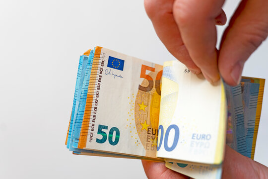 Person Counting Euro Banknotes. Person Holding Euro Banknotes.Lots of euro banknotes in palms. 