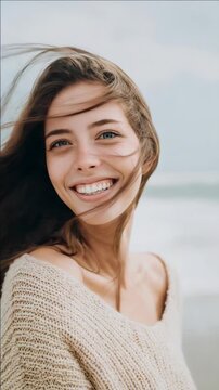 Smiling Woman with Wind-Blown Hair in a Knit Sweater