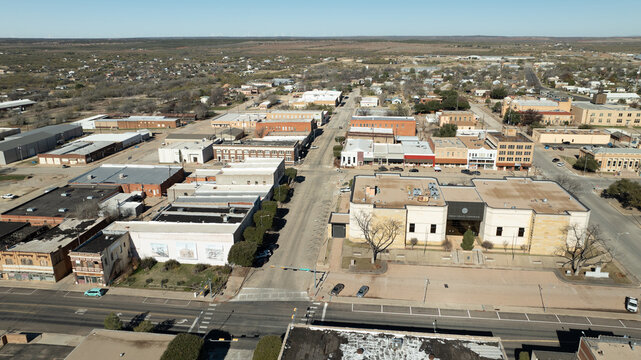 Sweetwater, United States - 16 December 2023: Aerial view of the Sweetwater skyline featuring historic downtown buildings, grid streets, and surrounding landscape under a clear sky.