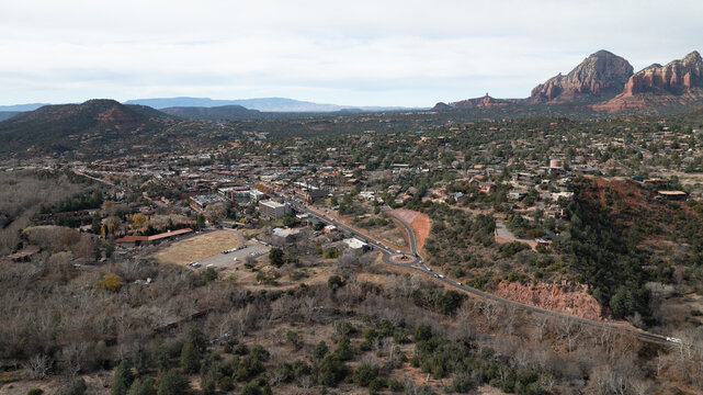 Sedona, United States - 30 December 2023: Aerial view of the Sedona skyline featuring iconic red rock formations, desert landscape, and urban development under a clear sky.