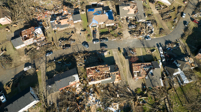 Little Rock, Arkansas, United States - 21 March 2023: Aerial view of tornado damage showing destroyed houses, debris-strewn streets, and fallen trees in a residential neighborhood.