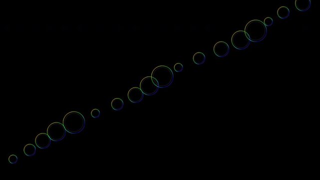 Rainbow soap film rings floating diagonally on a transparent background with alpha channel
