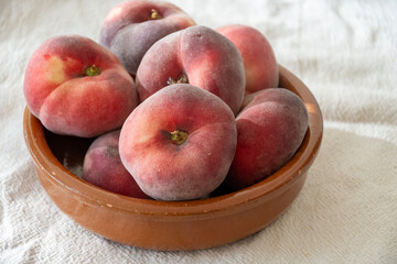 Flat peaches, Saturn sweet peaches from Mediterranean orchards, ripe Prunus persica seasonal fruit, harvest, orchard-grown fruit © barmalini