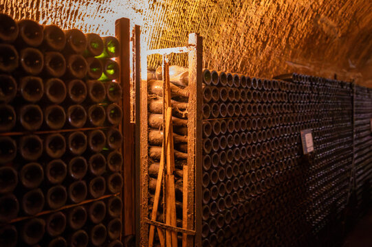 Champagne cellars in Epernay, underground chalk tunnels with systematic bottle storage and aging facilities, wine making industrial production and historical infrastructure, Champagne, France.