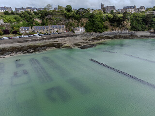 Aerial drone view of underwater oyster farms in Cancale, Brittany, exposed during low tide, raditional sustainable aquaculture and production of premium French oysters, France © barmalini