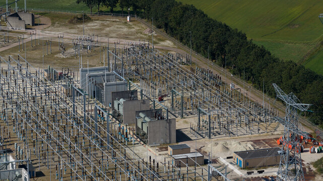 Aerial view of the Hoogspanningsstation Meeden high-voltage substation with electrical transformers, switchgear, and power lines in Meeden, Groningen, Netherlands.