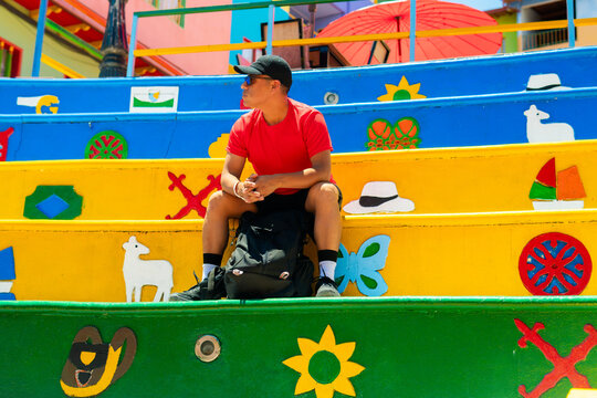 Man traveling guatape sitting on colorful zocalos