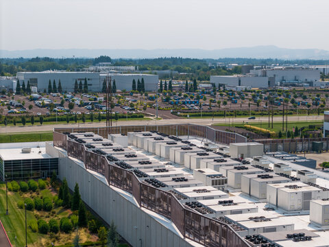 Aerial view of Hillsboro data centers featuring industrial buildings with rooftop cooling units, parking lots, and green landscaping in Hillsboro, Oregon, United States.