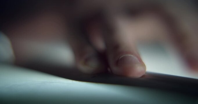 Extreme close-up of man's hand drawing a technical blueprint with a pencil and ruler, captured with shallow depth of field. Detailed drafting and design concept representing architecture, engineering.